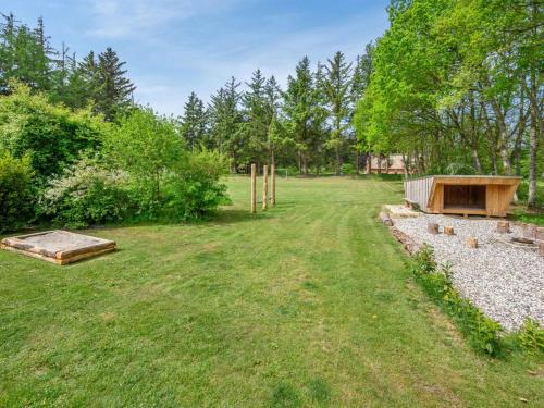 a yard with a sandbox and a wooden structure at Holiday Home Erla - 2-3km from the sea by Interhome in Ulfborg