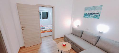 a living room with a couch and a table at Apartmani ANDRIJA in Živogošće