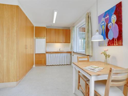a kitchen and dining room with a table and a refrigerator at Holiday Home Martinus - 5-5km from the sea by Interhome in Tim
