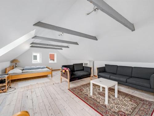 a living room with two couches and a table at Holiday Home Orvo - 150m from the sea by Interhome in Harboør