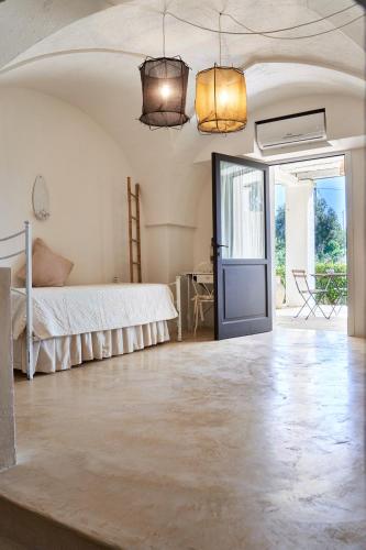 a bedroom with a bed and a glass door at Il Trappetello in Monopoli