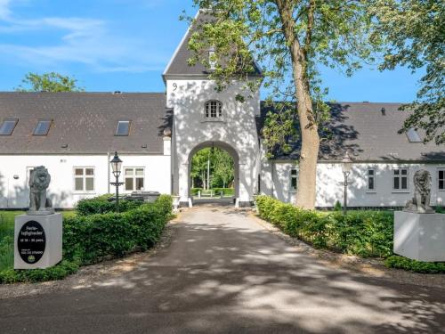 an entrance to a white building with an arch at Apartment Edine - 4-5km from the sea by Interhome in Ulfborg