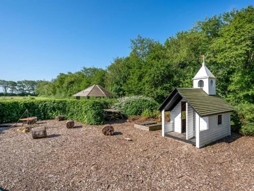 a small white chapel sitting in a gravel yard at Apartment Edine - 4-5km from the sea by Interhome in Ulfborg
