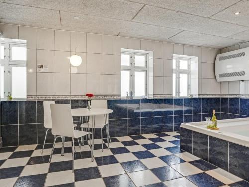 a kitchen with a table and chairs and a tub at Apartment Edine - 4-5km from the sea by Interhome in Ulfborg