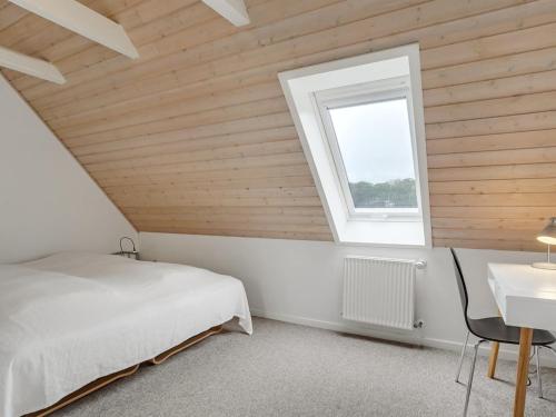 a bedroom with a bed and a window at Apartment Edine - 4-5km from the sea by Interhome in Ulfborg
