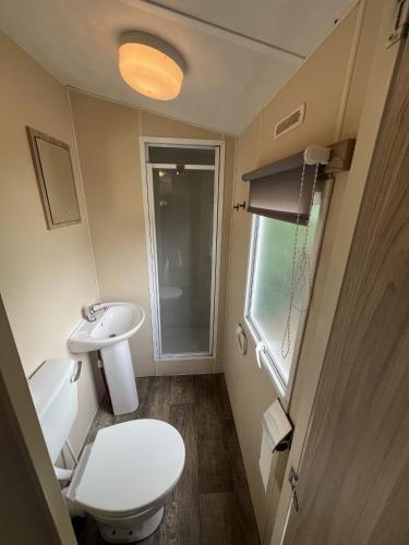 a small bathroom with a toilet and a sink at RBR 166 - Beach Resort Kamperland in Kamperland