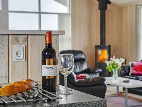 a bottle of wine and a glass on a counter at Holiday Home Frido - 400m from the sea by Interhome in Torsted