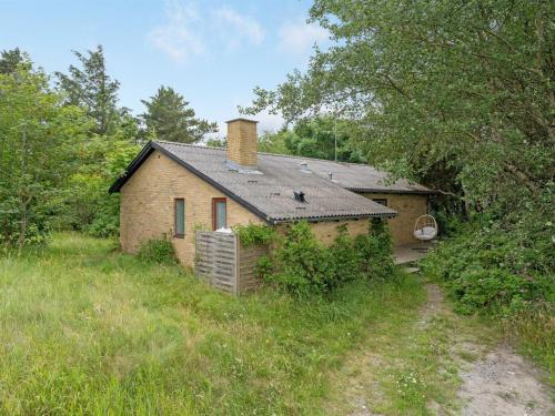 a small brick house in a grassy field at Holiday Home Flor - 900m from the sea by Interhome in Torsted
