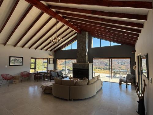 a large living room with a couch and a tv at Vultures View in Elandskop