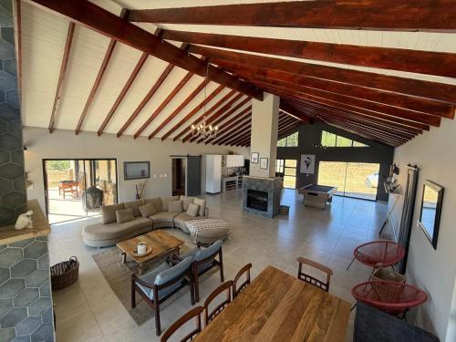 a living room with a couch and a table at Vultures View in Elandskop