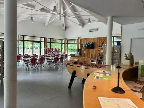 a large room with a table and chairs in it at Lacanau, 6 personnes, à côté du lac, sous les pins au calme in Lacanau