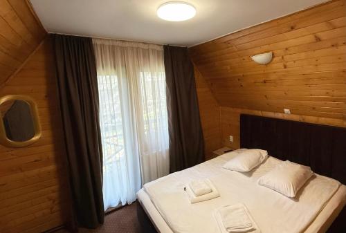a bedroom with a large bed and a window at Casa Familiei in Braşov