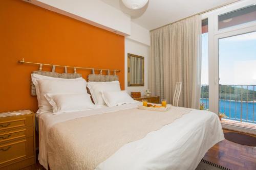 a bedroom with a large bed and a large window at Apartment Love and Hope in Dubrovnik