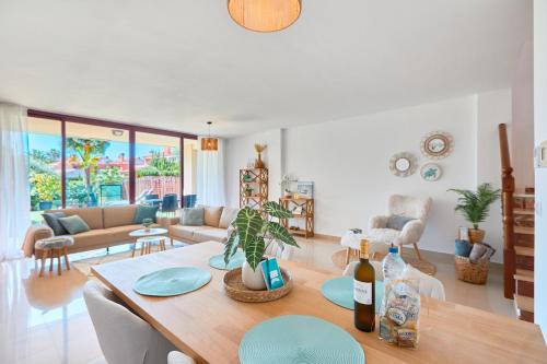 a living room with a table and a living room at Charming Bungalow in Venta Lanuza - by Welcomely in El Campello