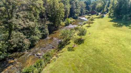 an aerial view of a river next to a field at Cabin at Cranberry Mill - Private Creekfront Cabin in Laurel Springs 