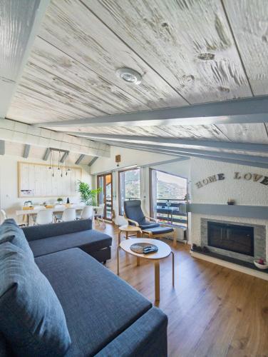 a living room with a couch and a fireplace at Cocon familial avec vue au centre de Veysonnaz in Veysonnaz