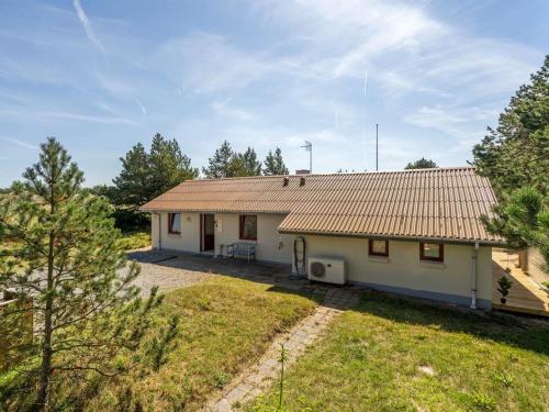 a small white house with a roof at Holiday Home Germund - 900m from the sea by Interhome in Torsted