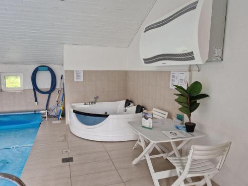 a living room with a boat next to a pool at Holiday Home Germund - 900m from the sea by Interhome in Torsted