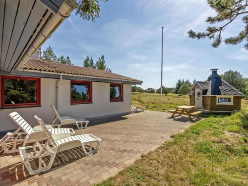 a patio with rocking chairs and a house at Holiday Home Germund - 900m from the sea by Interhome in Torsted