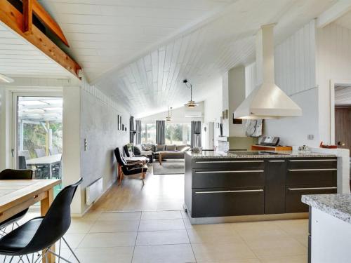 a kitchen with a counter and a living room at Holiday Home Germund - 900m from the sea by Interhome in Torsted