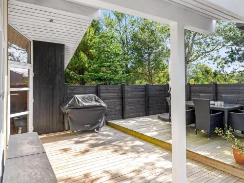 a patio with a table and a fence at Holiday Home Ansfried - 900m from the sea by Interhome in Torsted
