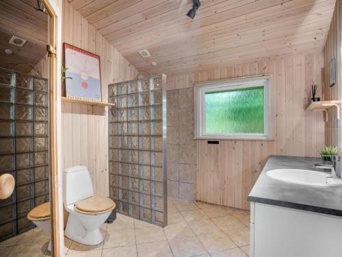 a bathroom with a toilet and a sink at Holiday Home Ansfried - 900m from the sea by Interhome in Torsted