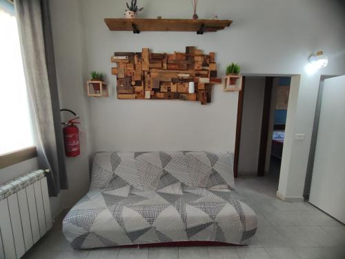 a living room with a chair and a wall with a picture at Appartamento Gigio - Incisa Valdarno in Vivajo
