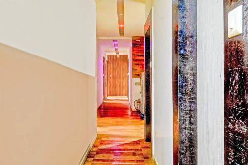 a hallway of a house with wood floors at Hotel O Angel Park in Ahmedabad