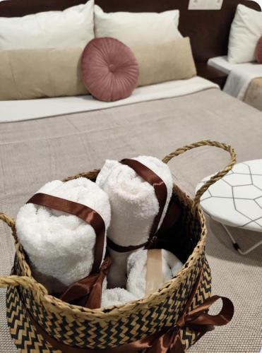 a basket filled with towels in a room with a couch at Filippos studios in Leptokaria