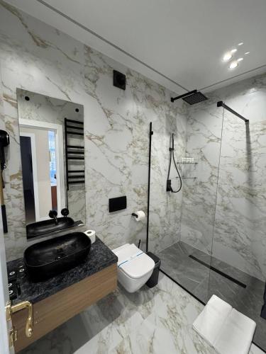a bathroom with a sink toilet and a shower at Rinvoks boutique hotel in Kremenchuk