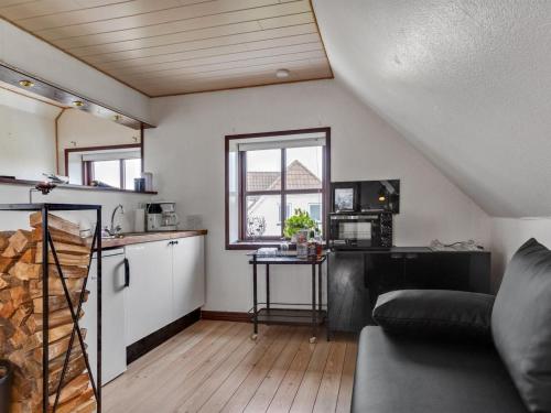 a living room with a couch and a kitchen at Holiday Home Amely - 500m from the sea by Interhome in Sæby