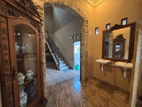 a hallway with two sinks and a staircase in a house at Good Feeling Ijen Banyuwangi in Banyuwangi