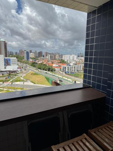 a window in a room with a view of a city at Flat 706 próximo à praia - Condomínio Biarritz in São Luís