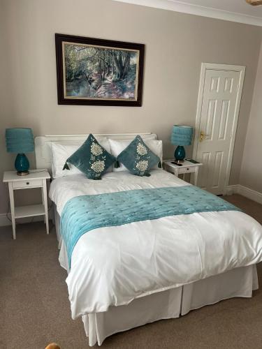 a bedroom with a bed with two night stands at Harbour House B&B in Courtown