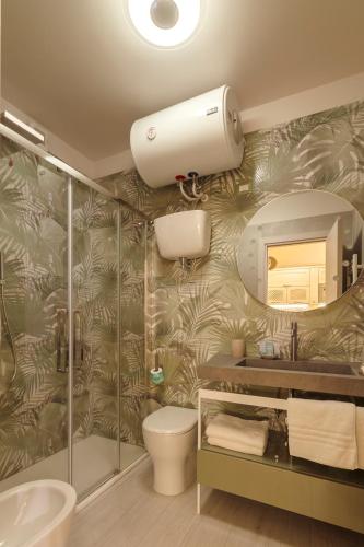 a bathroom with a shower and a toilet and a mirror at La Dimora dell'Ufficiale DELUXE in Foligno