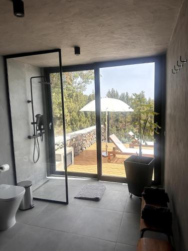 a bathroom with a view of a deck with an umbrella at Casa Arriettas in Tijarafe