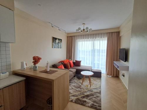 a living room with a couch and a table at Caster two bedrooms apartment jkia in Nairobi