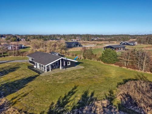 an aerial view of a house on a grassy field at Holiday Home Nynke - 600m from the sea by Interhome in Løkken