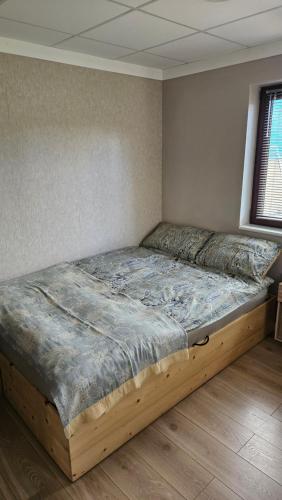 a bed with a wooden frame in a room at Killarney Cosy Hideaway in Killarney