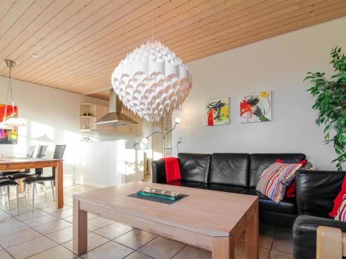 a living room with a couch and a table at Apartment Frænde - 600m from the sea by Interhome in Løkken