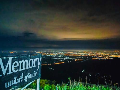 a sign sitting on top of a hill at night at Memory เมมโมรี่ ภูทับเบิก in Ban Maeo Thap Boek