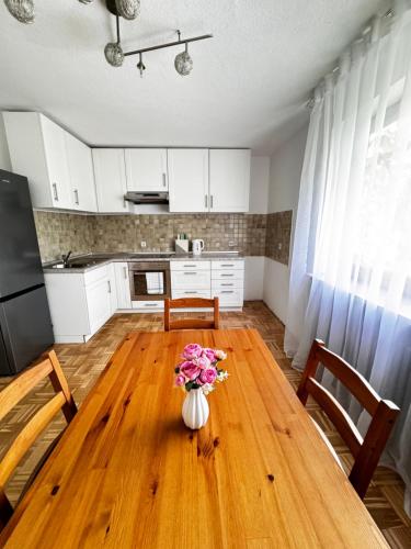 a dining room table with a vase of flowers on it at Vardi Haus in Ingolstadt