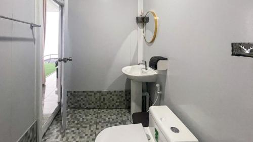 a white bathroom with a sink and a toilet at Memory เมมโมรี่ ภูทับเบิก in Ban Maeo Thap Boek