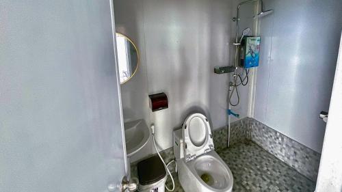 a small bathroom with a toilet and a sink at Memory เมมโมรี่ ภูทับเบิก in Ban Maeo Thap Boek