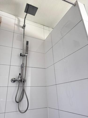 a shower with a shower head in a bathroom at Vardi Haus in Ingolstadt