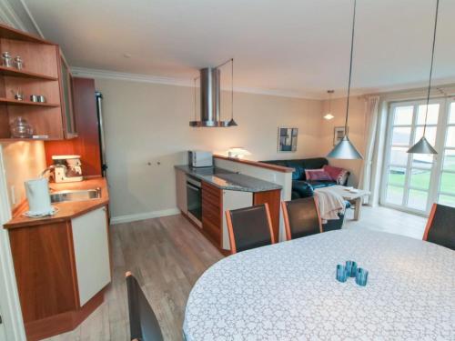 a kitchen and a living room with a table at Apartment Swarthovde - 300m from the sea by Interhome in Løkken