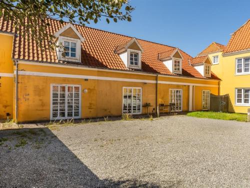 a large yellow building with white windows at Apartment Swarthovde - 300m from the sea by Interhome in Løkken