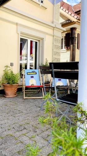 a group of chairs sitting outside of a house at Organic BnB Froschkoenig Rigi Burggeist in Gersau