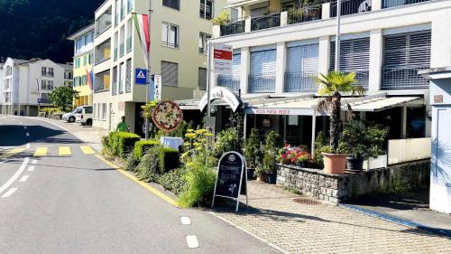 a street with a sign in front of a building at Organic BnB Froschkoenig Rigi Burggeist in Gersau