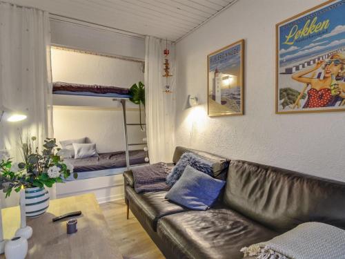a living room with a couch and a bunk bed at Apartment Ingert - 250m from the sea by Interhome in Løkken